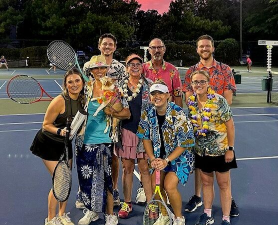 Stillfire Brewing Pickleball Team poses for a photo on a sunset lit court